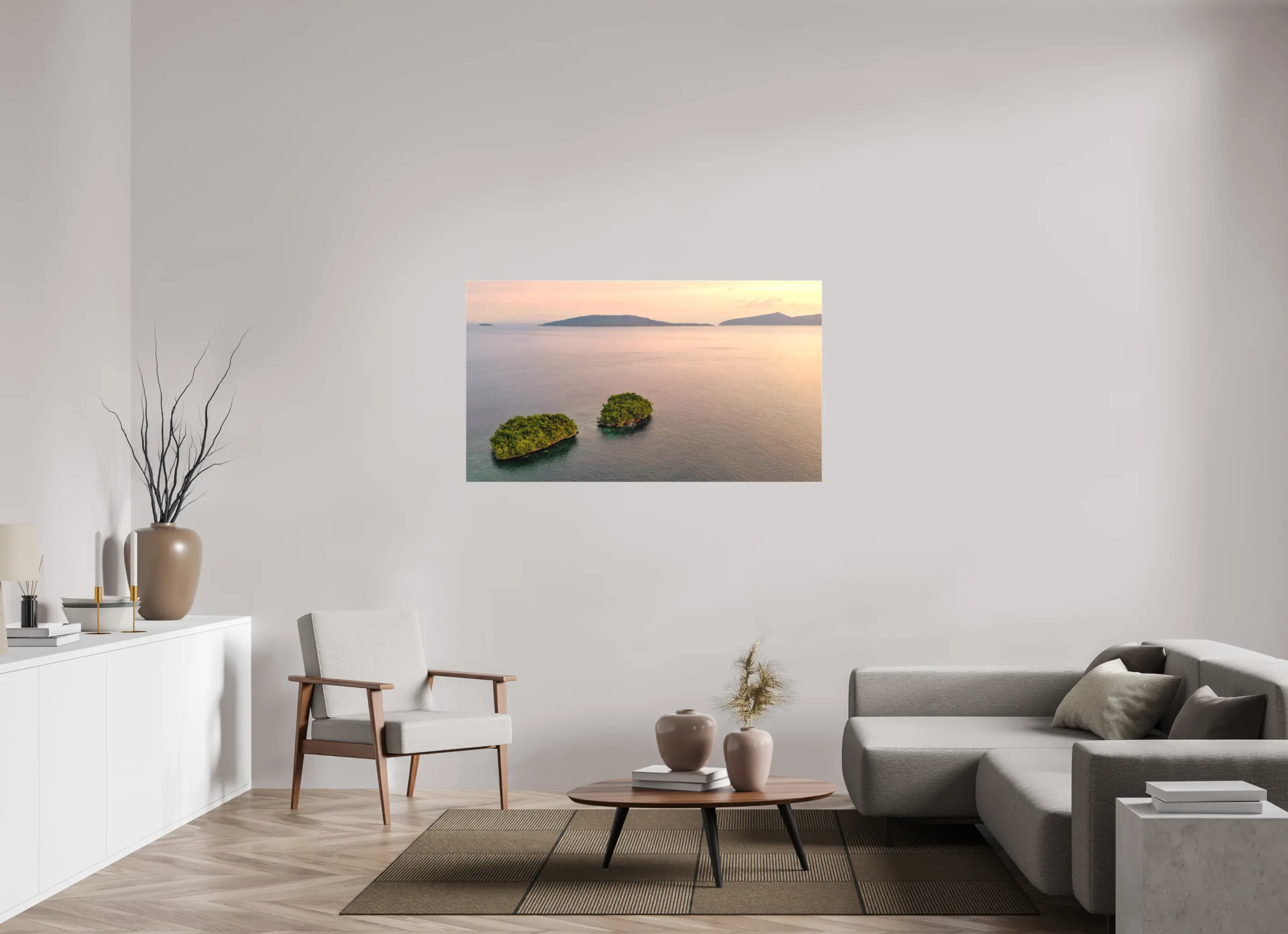 Fine art print “Siblings” featuring an aerial view of two small lush islands surrounded by calm pink waters at sunset in Raja Ampat Indonesia, displayed on a premium canvas print in a modern living room setting.