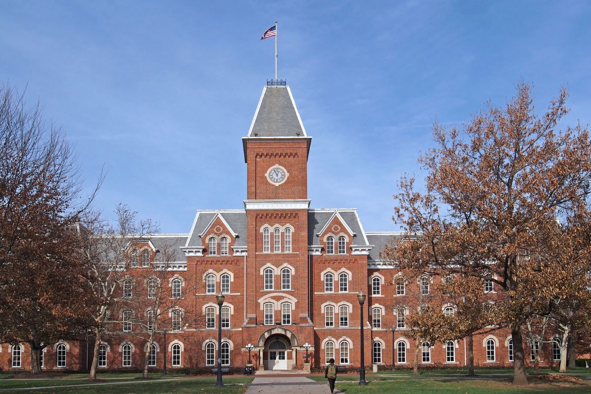 Historic university campus building with clock tower, representing higher education institutions facing growing I-9 compliance audit risks