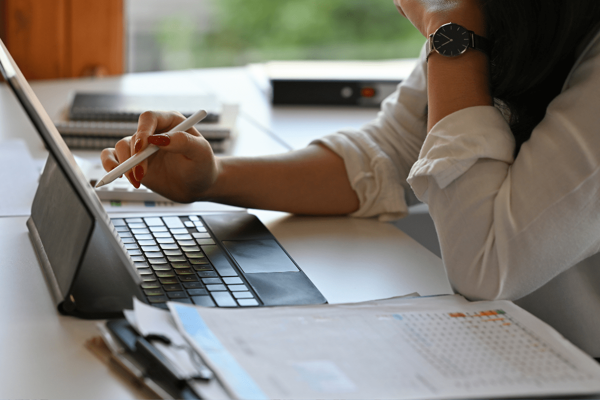 HR professional reviewing I-9 compliance documents and digital records on a laptop in 2025—concept of identifying common I-9 mistakes and improving audit readiness.