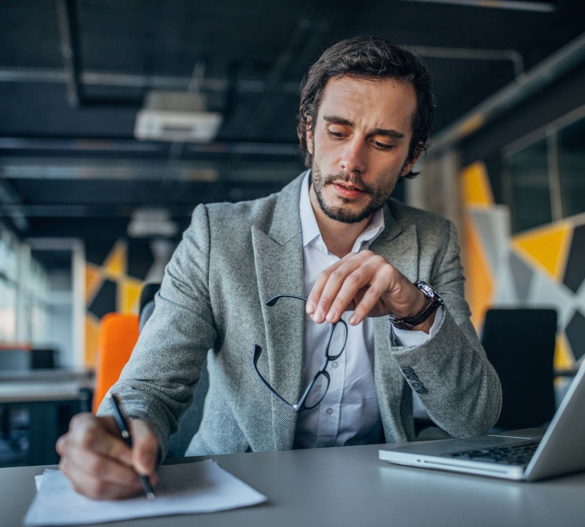 HR professional reviewing I-9 compliance documents and verification forms in a modern office setting.