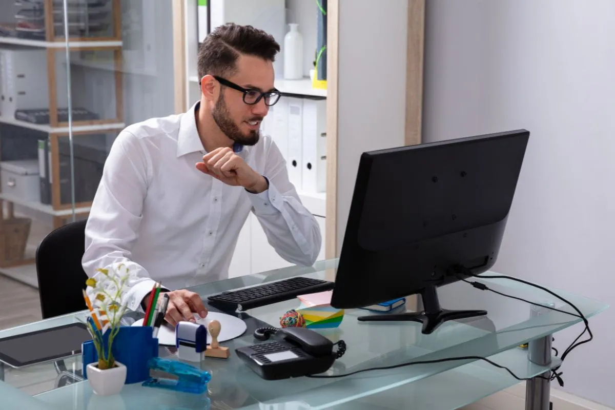 HR professional reviewing Form I-9 compliance corrections on a desktop computer to fix I-9 mistakes without creating audit risk 
