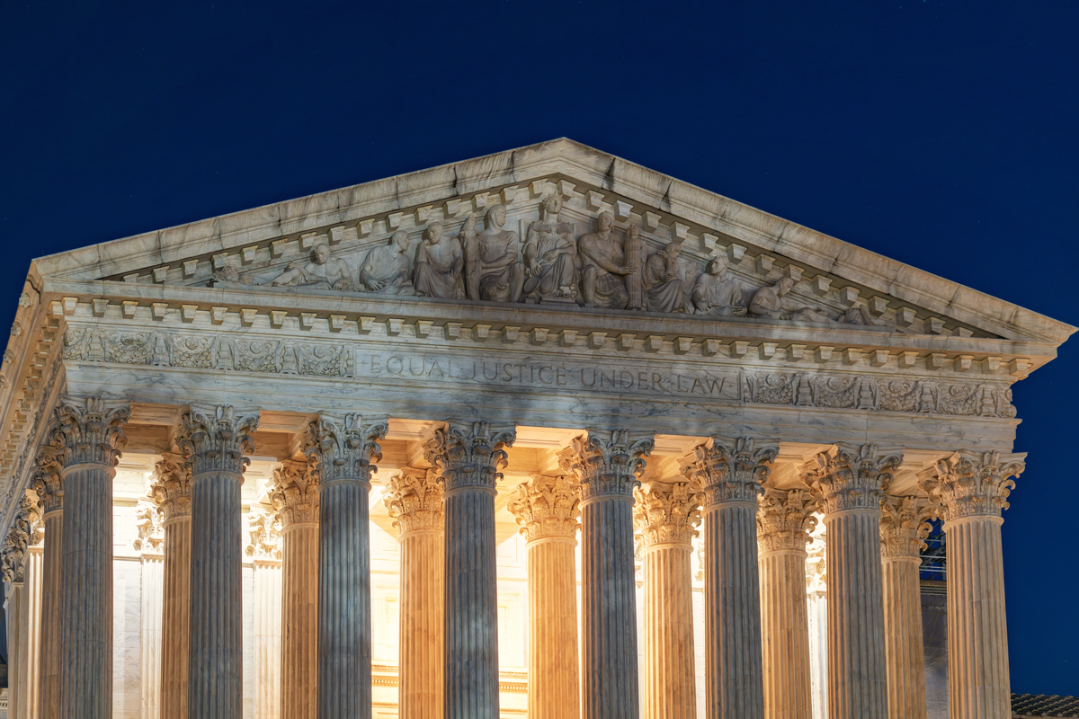 U.S. Supreme Court pediment illuminated at night with Equal Justice Under Law inscription