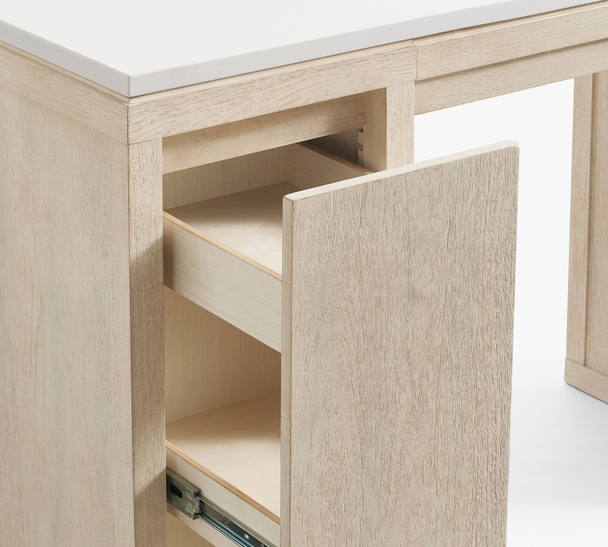 Close-up product image taken at an angle, showing the left side of the vanity. The light wood textured panel is open, revealing two internal pop-out drawers on smooth metal glides stacked vertically. The white quartz countertop is visible at the top.