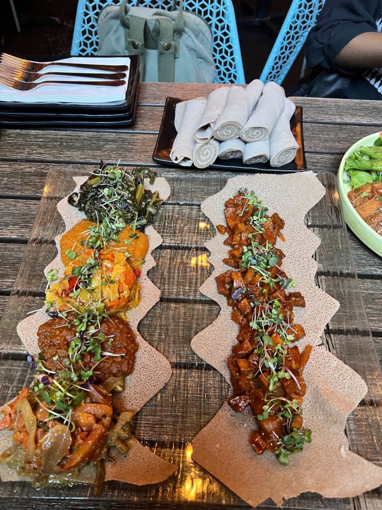 A wooden table topped with plates of food