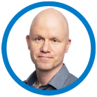 A man with a bald head wearing a gray shirt