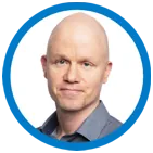 A man with a bald head wearing a gray shirt
