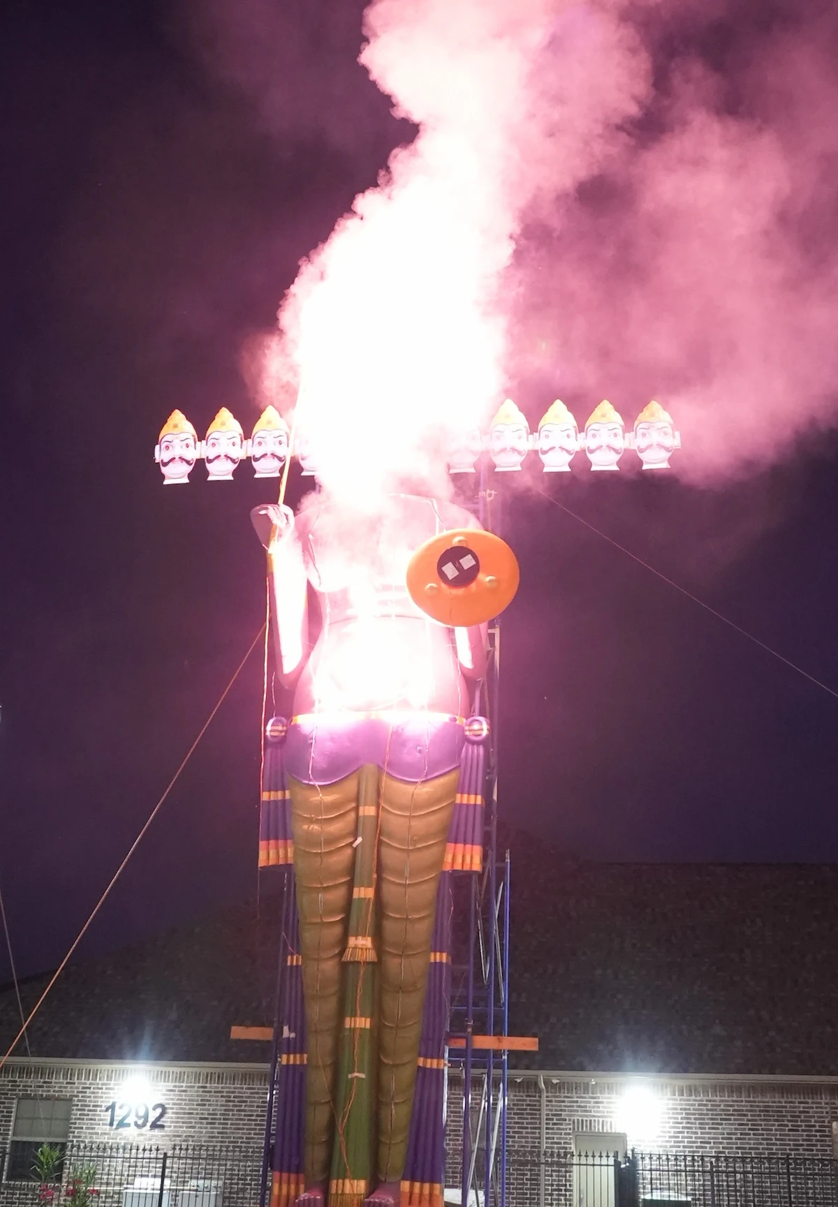 Flames and smoke rising from the ten-headed Ravan effigy at night.