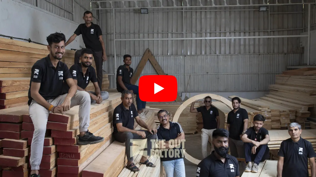 Team photo of wood workshop employees in matching black shirts