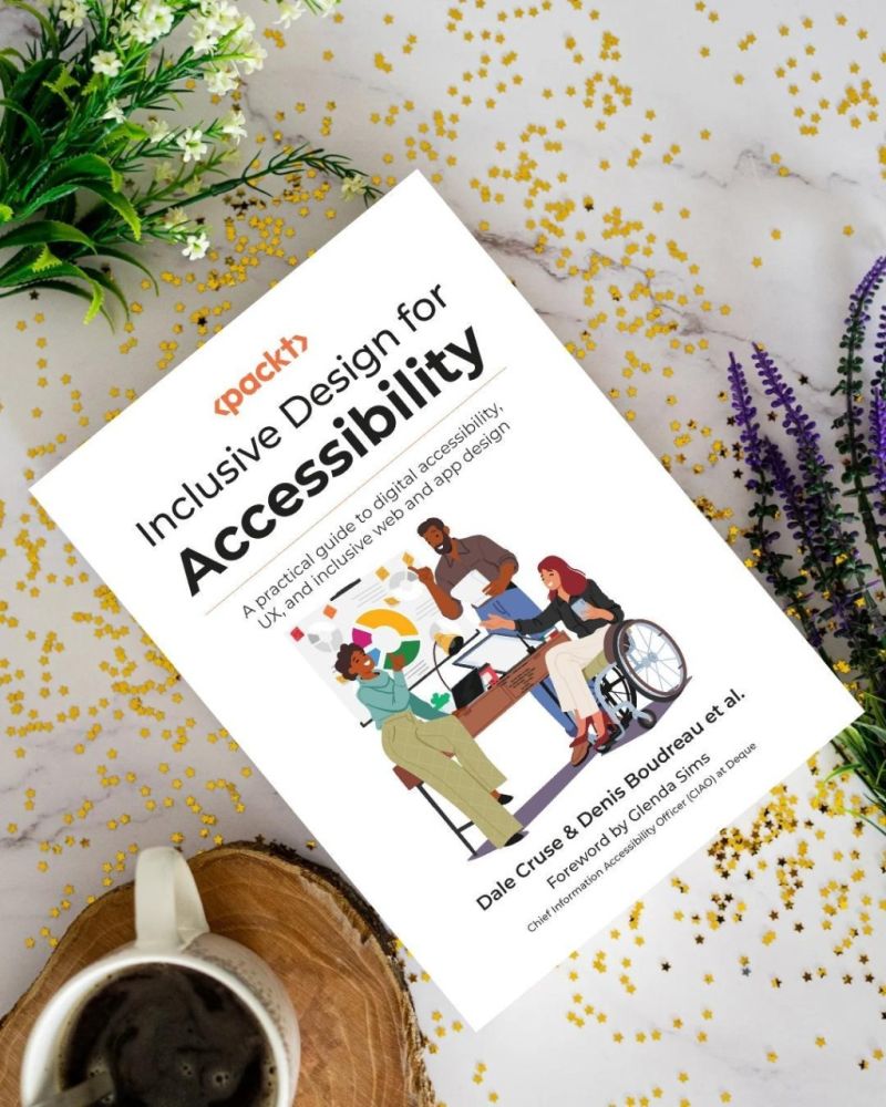 Inclusive Design for Accessibility book cover on decorated table with confetti and a cup of coffee