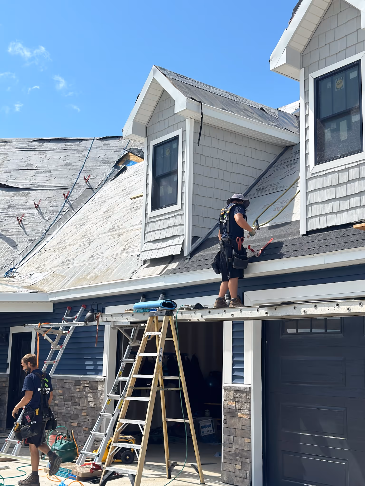 Homezone crew nailing a new roof for a homeowner in Michigan.