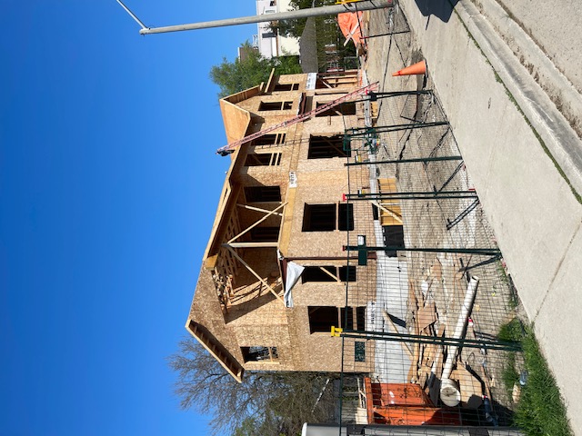 Framing stage of new custom home build in Mississauga, Ontario with roof structure being installed