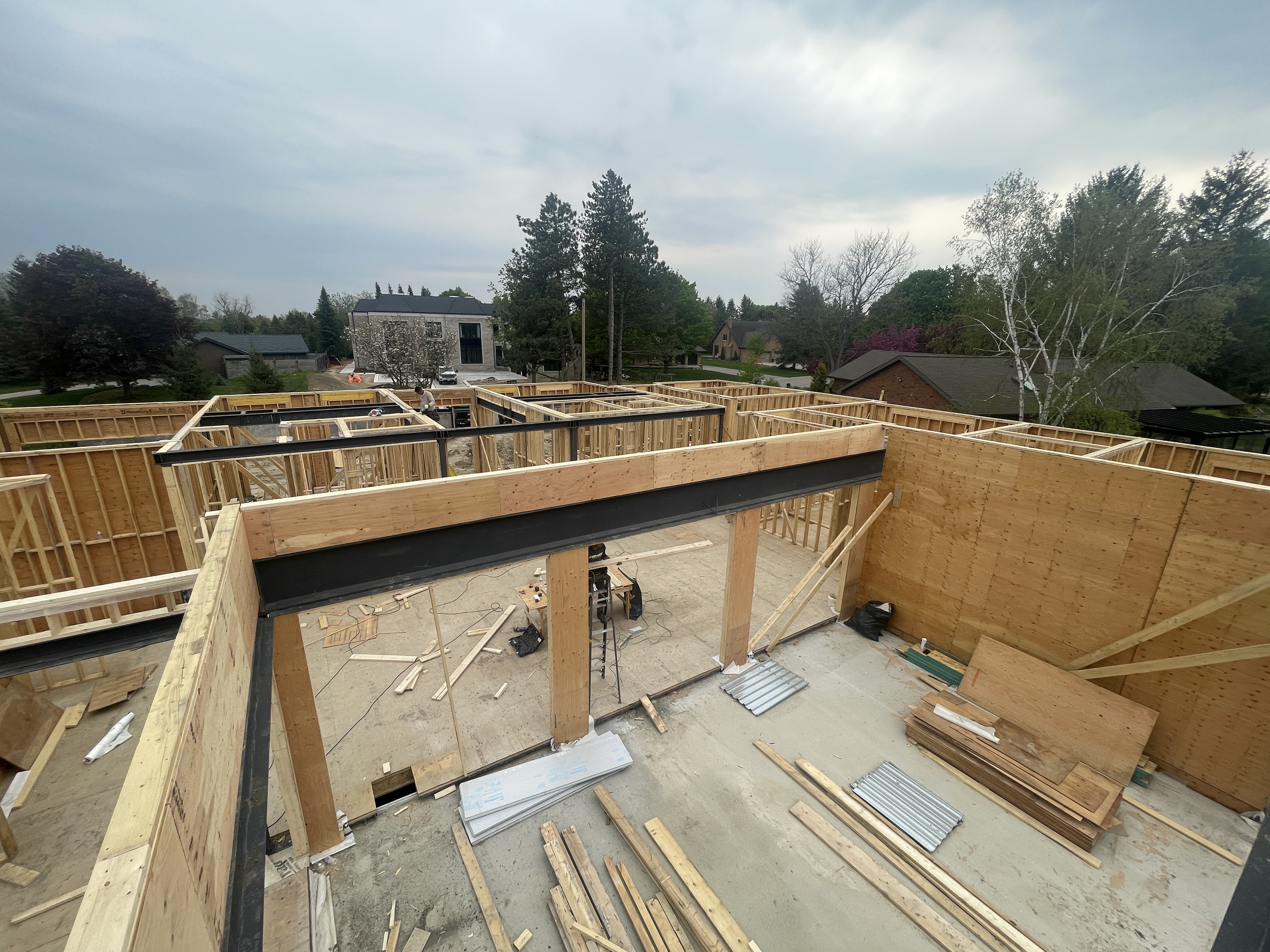 Engineered floor joist installation during custom home framing project in King city, Ontario