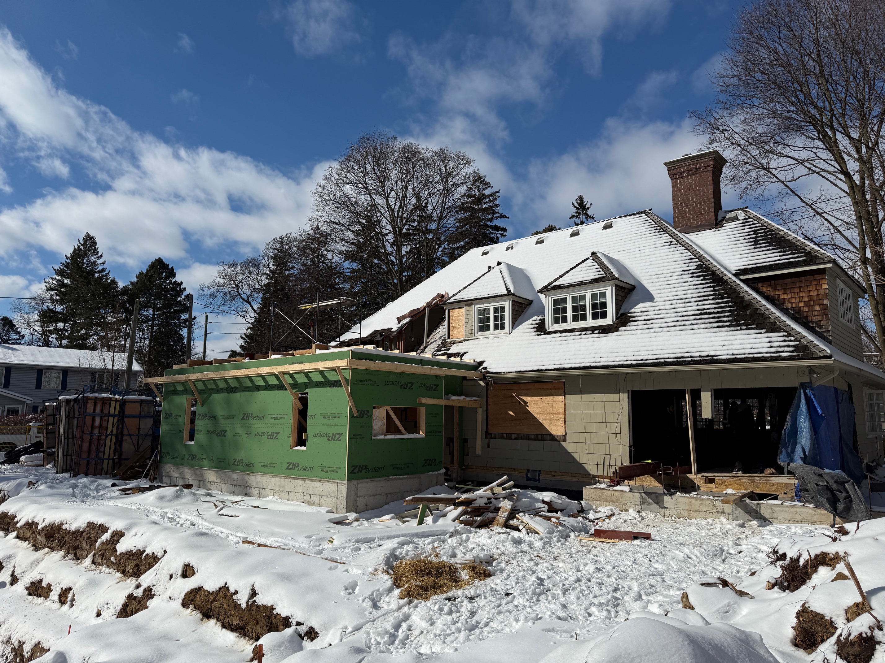 First floor walls completed and second floor framing in progress on heritage home addition in Oakville, Ontario