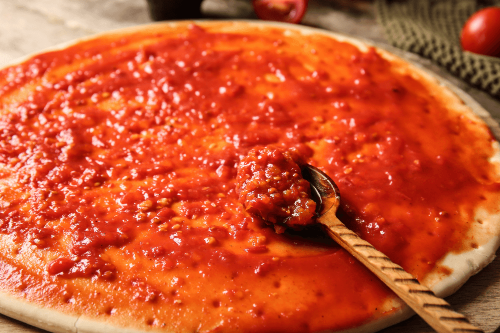 Une pizza généreusement garni de sauce tiate maison