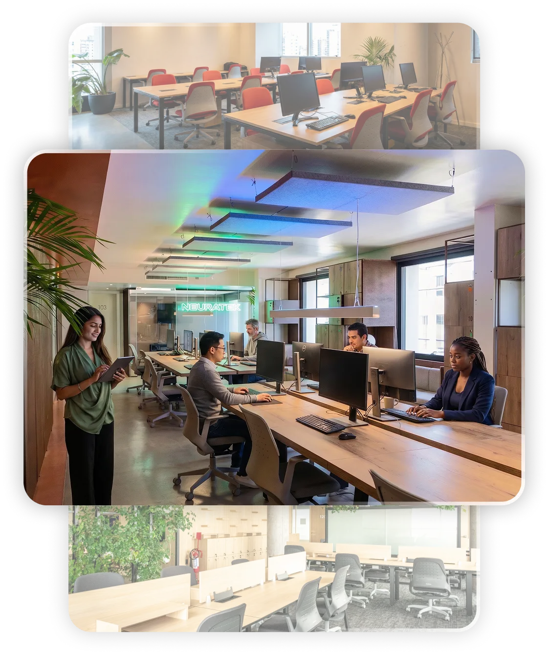 Oficina moderna con ventanales grandes, escritorios abiertos, plantas y vista urbana al atardecer.
