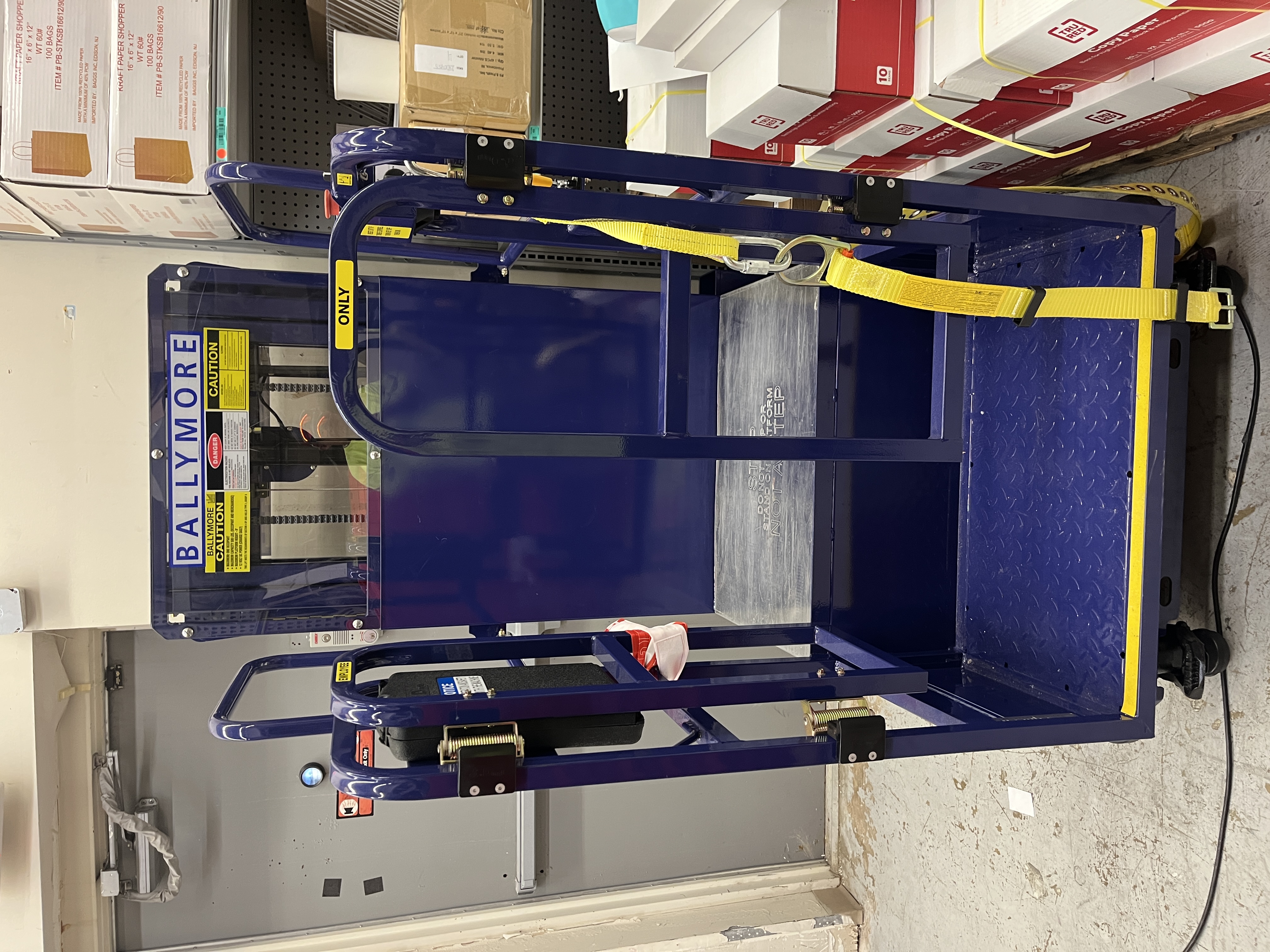 Ballymore PS-10 electric personnel stock picker lift with safety harness, non-slip platform, and control panel for warehouse and retail use