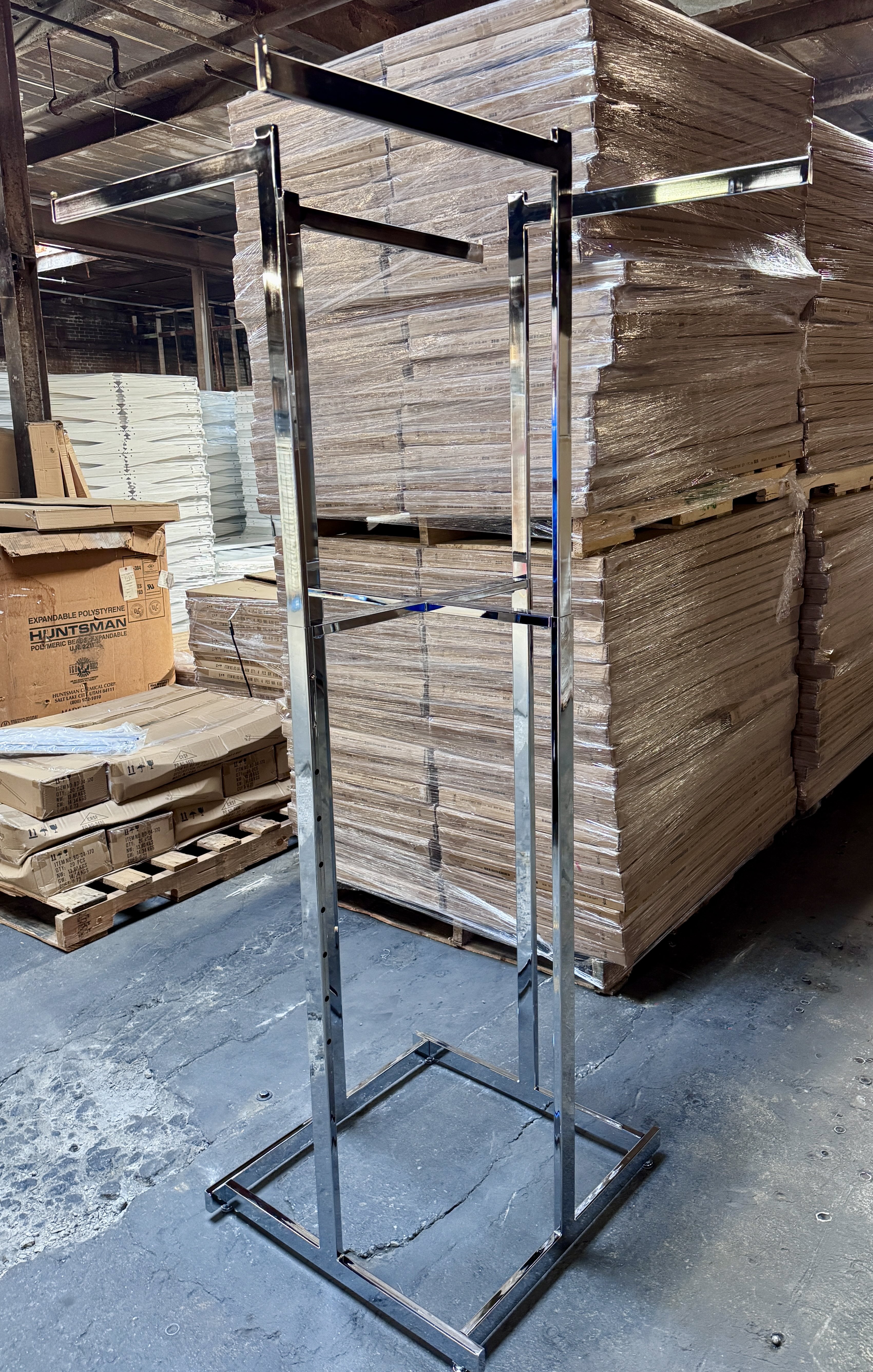 Chrome 4-way clothing rack for retail apparel displays, adjustable arms for merchandising shirts, jackets, and garments. New retail clothing racks available from Mid-America Store Fixtures.