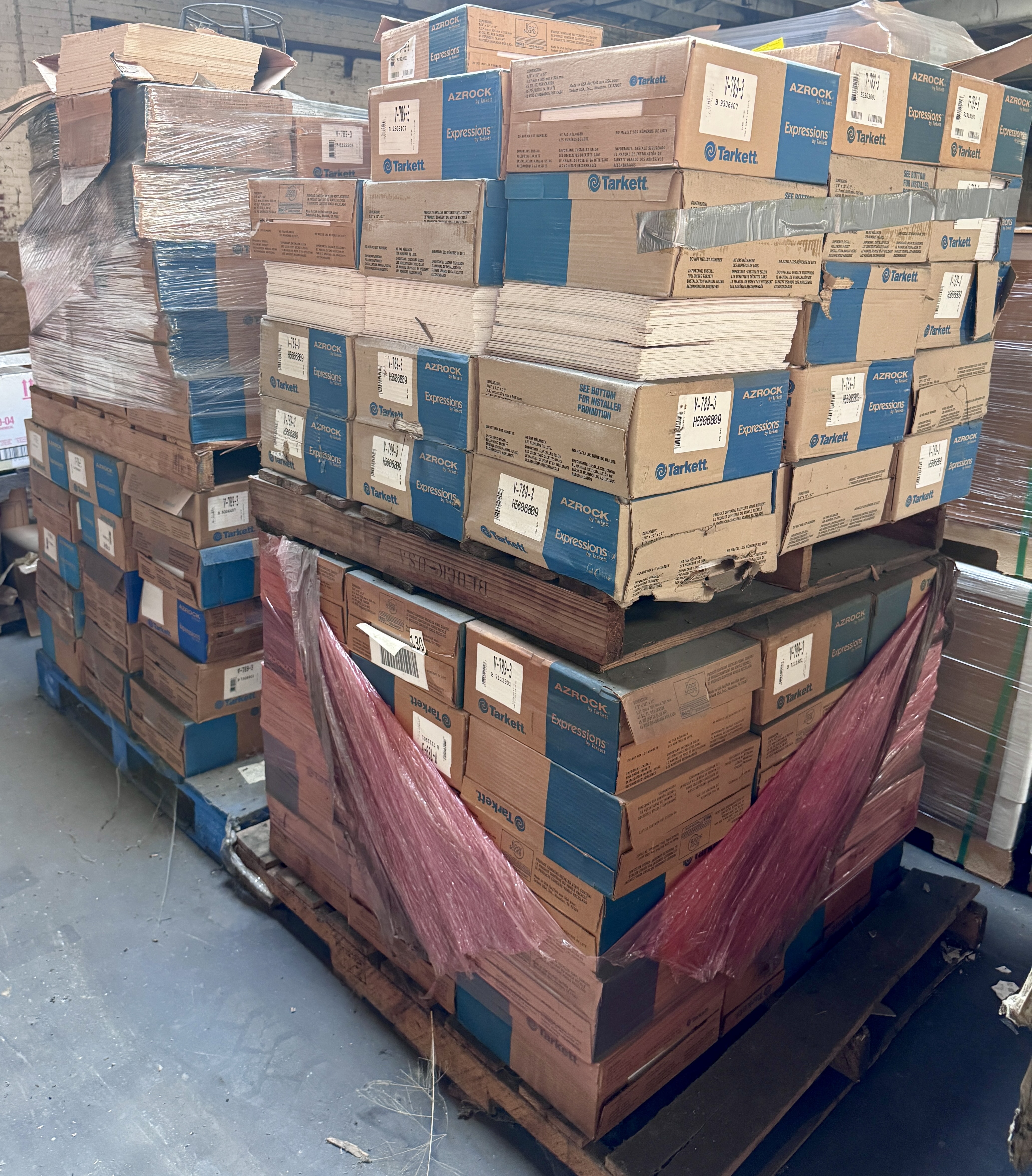 Close-up of commercial 12x12 vinyl composite tile with light beige and tan marbled pattern, ideal for retail stores, grocery floors, and commercial facilities. Vinyl flooring available from Mid-America Store Fixtures.