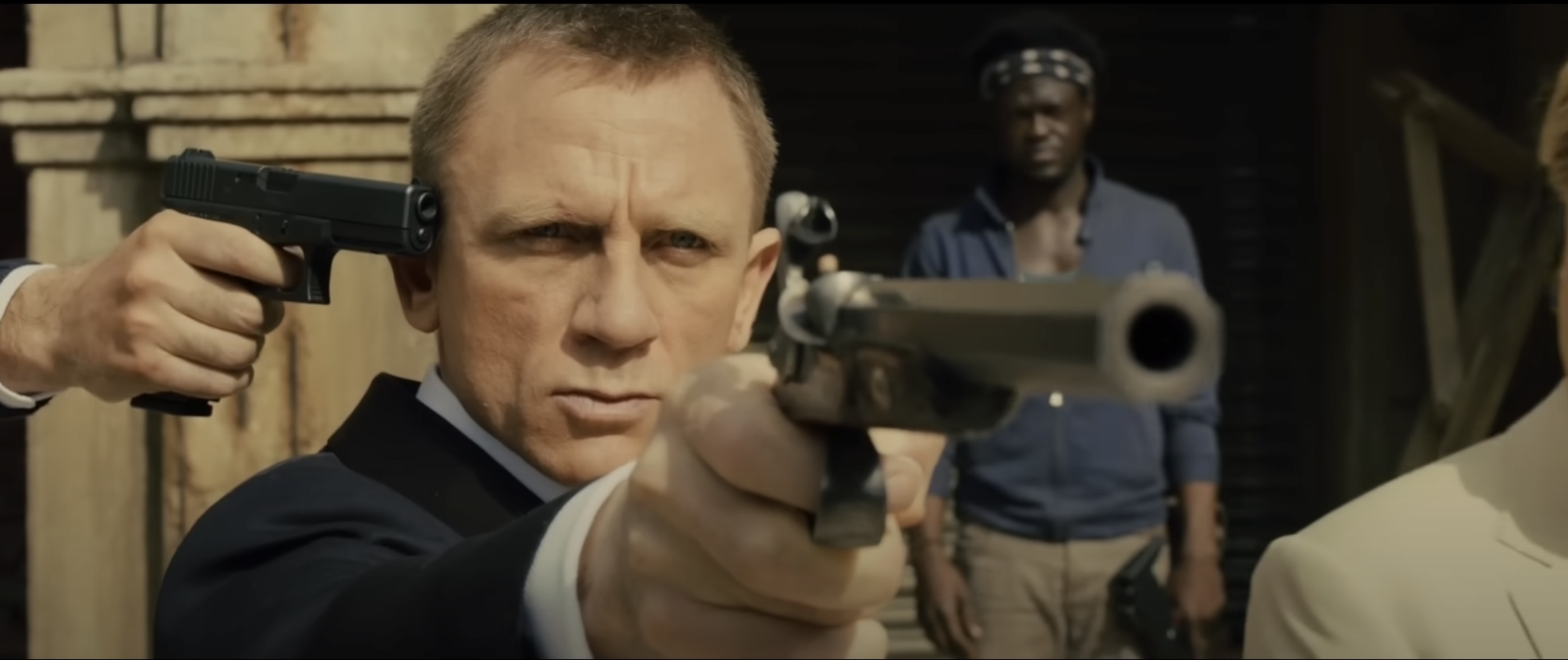 The scene from James Bond Skyfall When James Bond is told to shoot the glass on top of a woman whilst someone is holding a gun to his head otherwise they will shoot him 