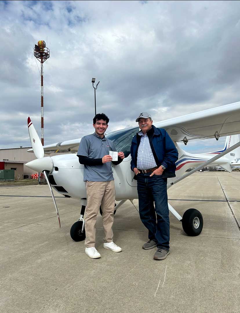 two men next to plane