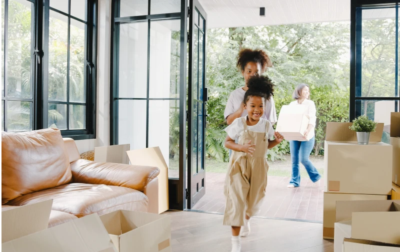Two children entering their new home that was purchased using a down payment assistance grant from Virginia Housing.