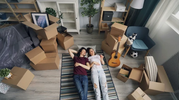 A young couple celebrating their first home, purchased using the Virginia Housing Second Mortgage Plus.