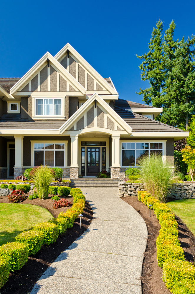 A family standing in front of their new home, which was financed with a Jumbo mortgage.