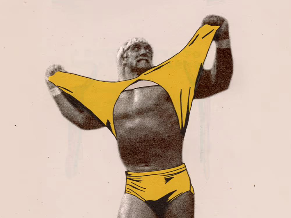 Muscular man pulling off a yellow singlet, revealing his chest and wearing yellow trunks.