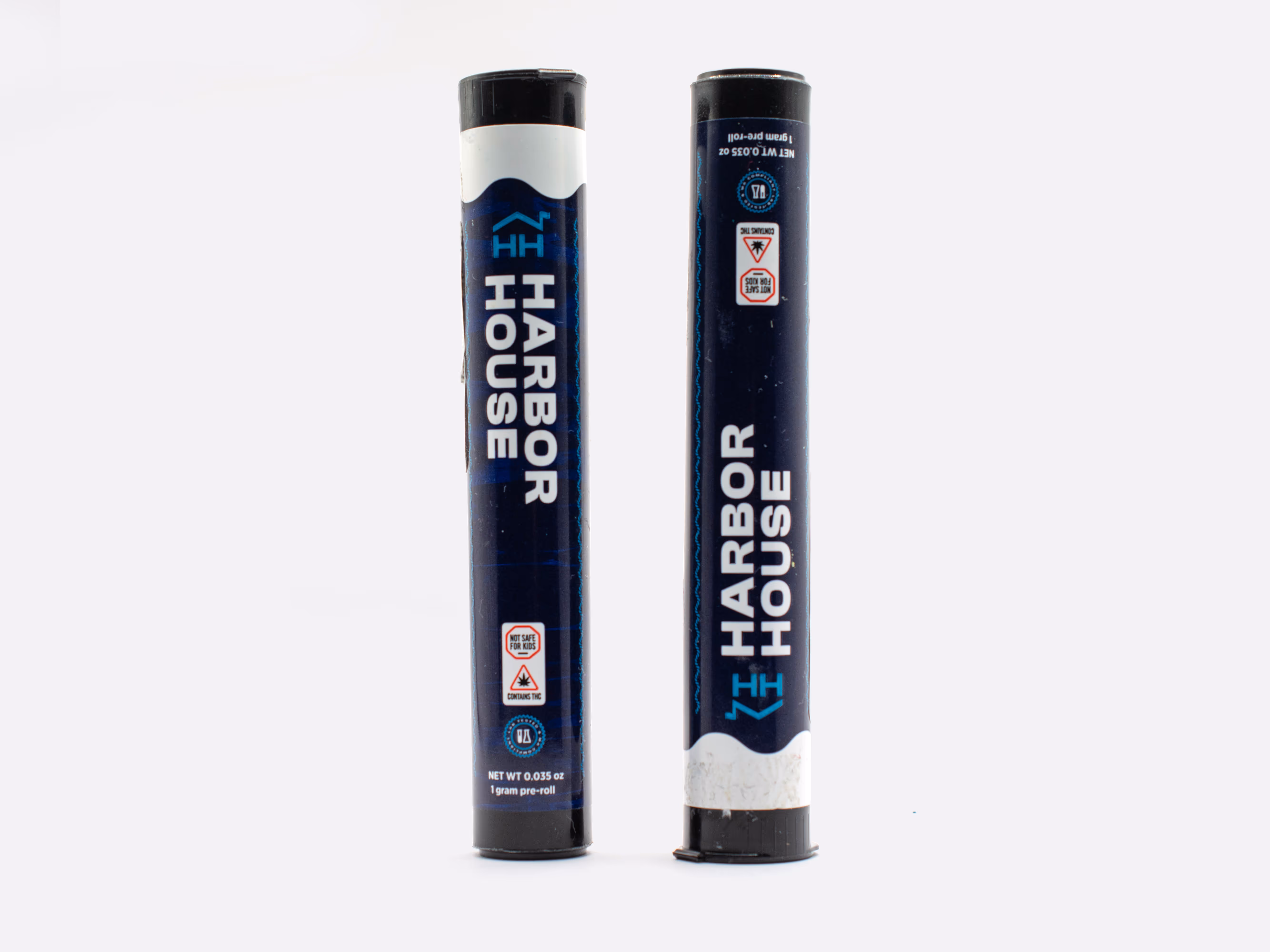 Two dark blue cylindrical tubes standing upright with white caps, labeled Harbor House 1 gram pre-roll, featuring safety and THC warning icons.