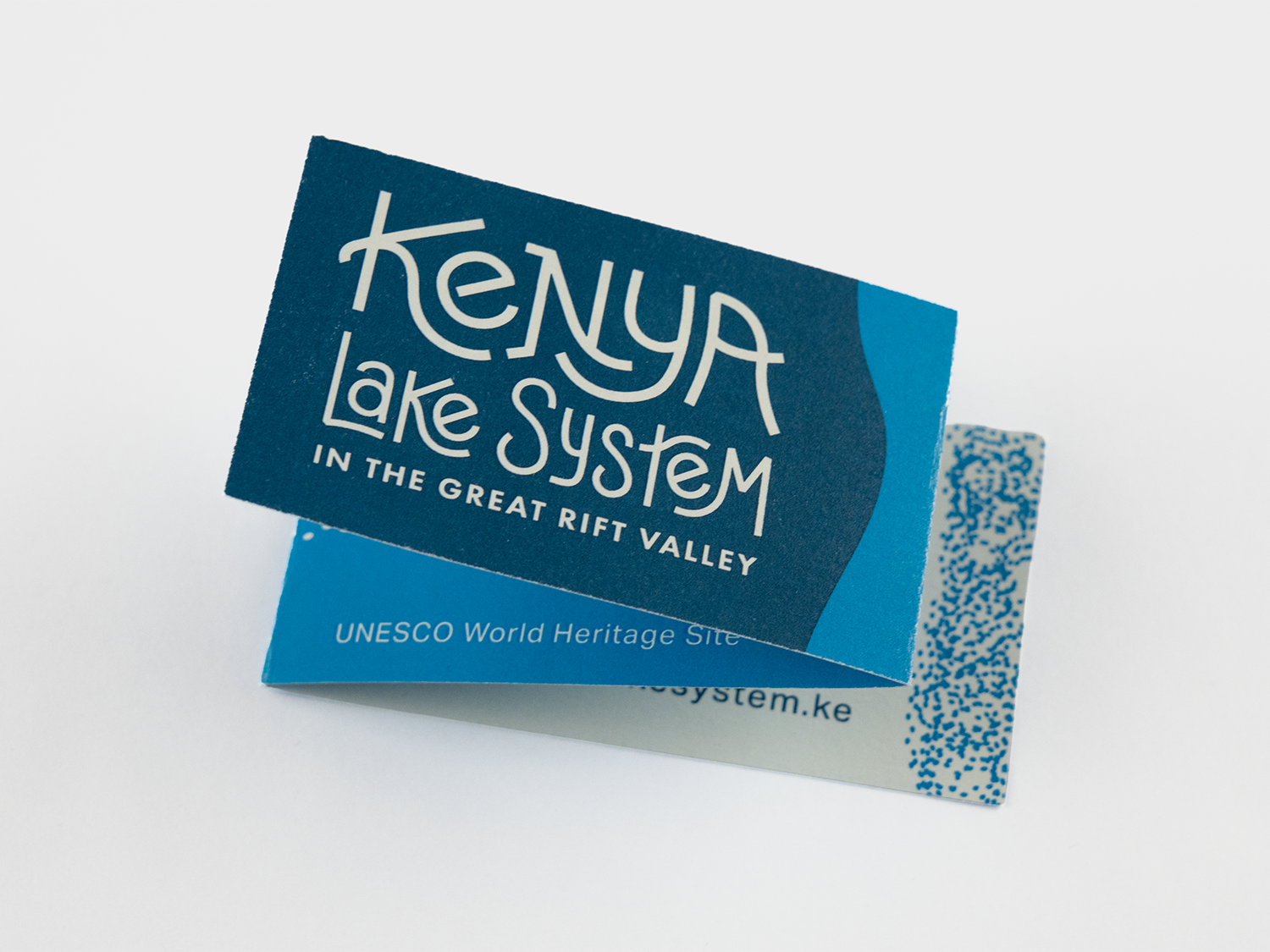 A trifolded business card that says 'Kenya Lake System in the Great Rift Valley' in stylized white text.