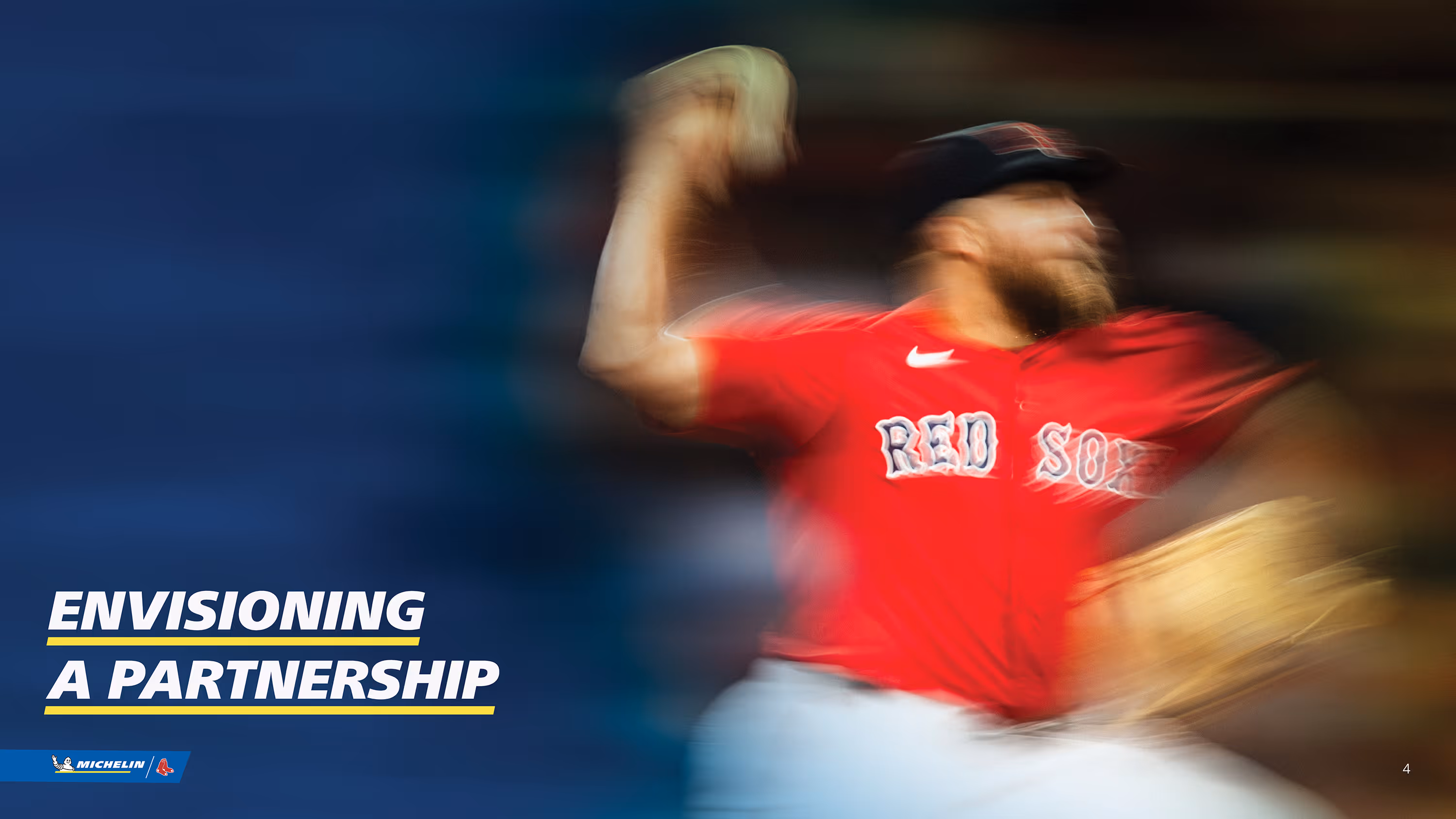 Blurred action shot of a baseball pitcher in a red Boston Red Sox uniform throwing a pitch, with text 'Envisioning a Partnership' and Michelin and Red Sox logos.