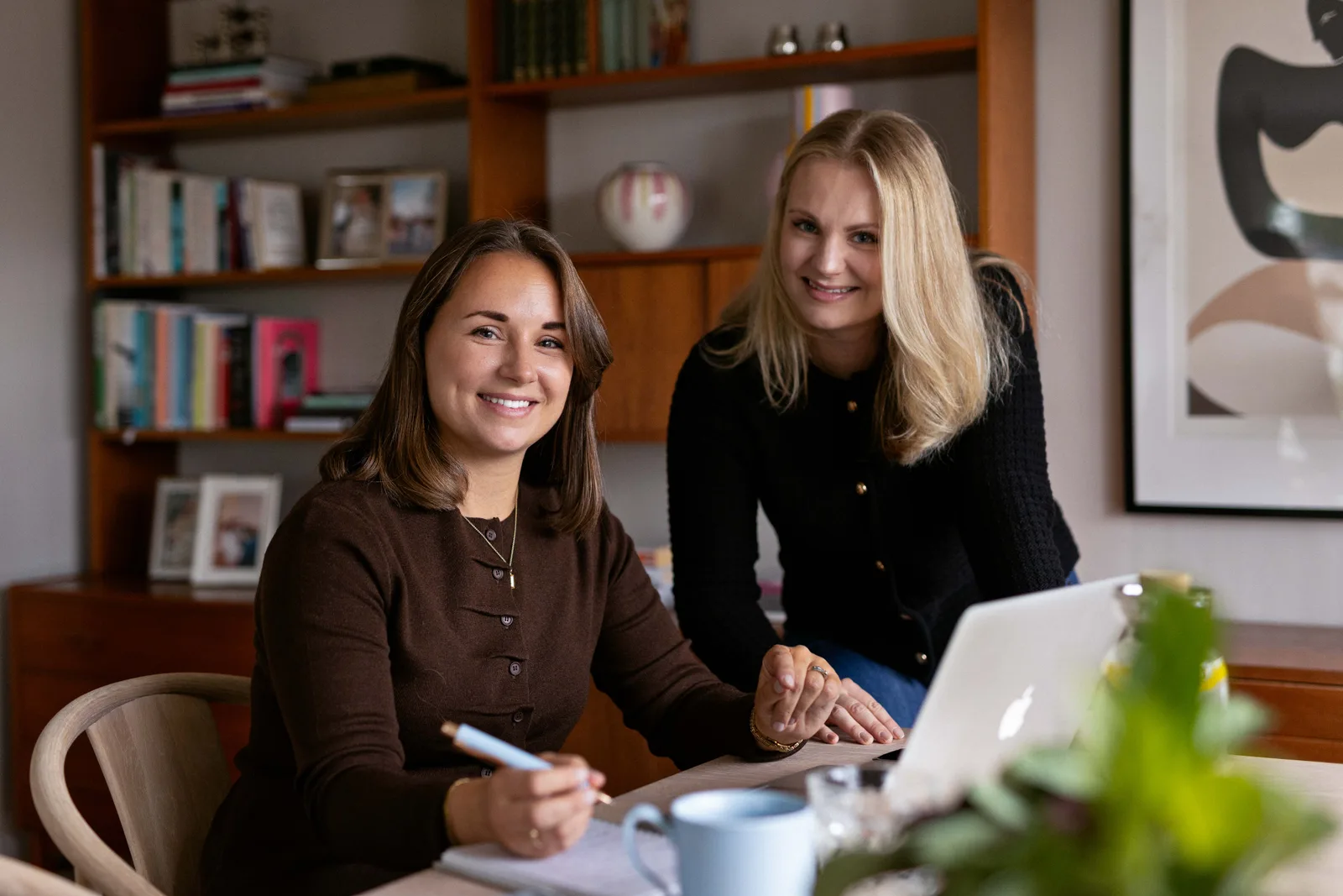 Two colleagues working together in a warm office environment
