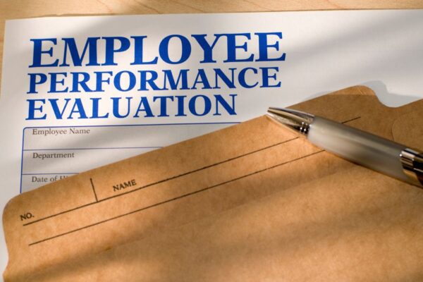 A formal employee performance evaluation document and folder