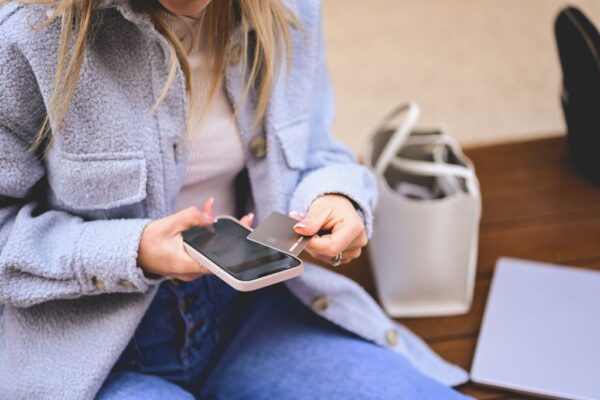 Woman using a credit card to pay for something on her phone
