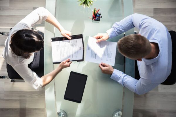 Reviewing roofer resumes at a table