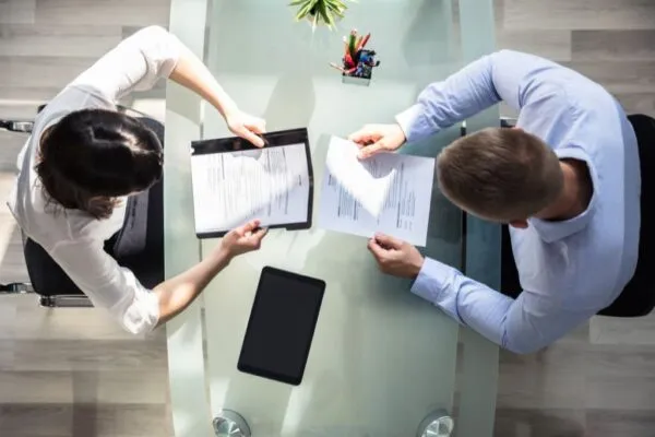 Reviewing roofer resumes at a table