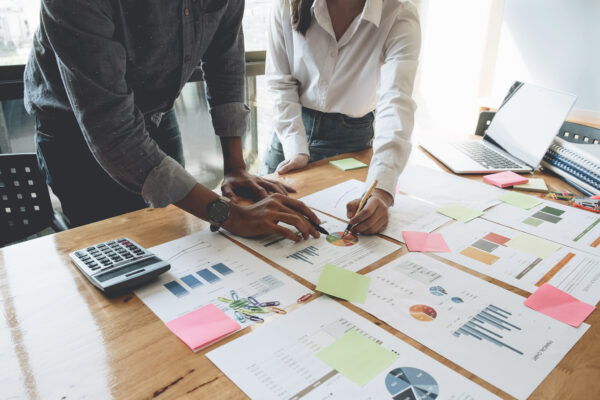 roofing office staff looking printed reports and plans