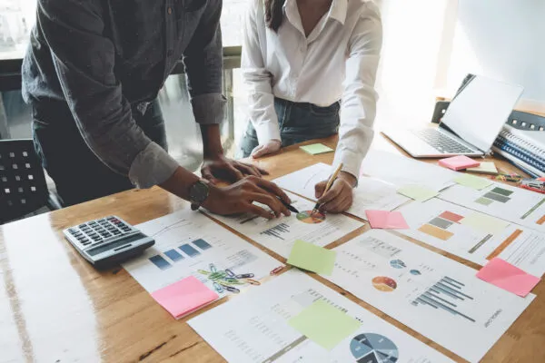 roofing office staff looking printed reports and plans