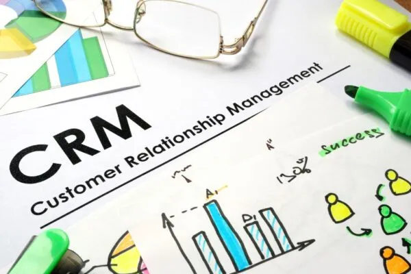 A paper with graphs and charts with the word Customer Relationship Management