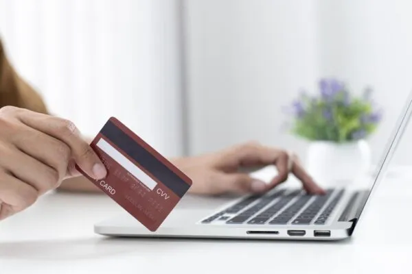 A customer paying a contractor with a credit card on their laptop