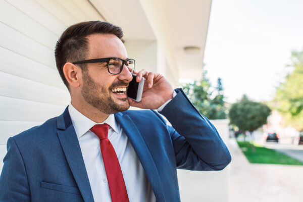 smiling roofing salesman on the phone