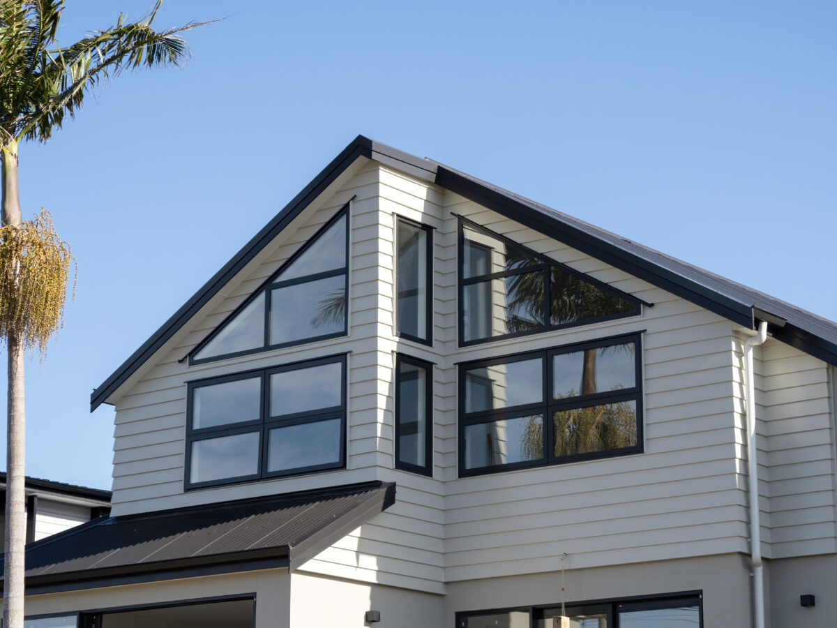 white and black home with skillion double-pitch roof