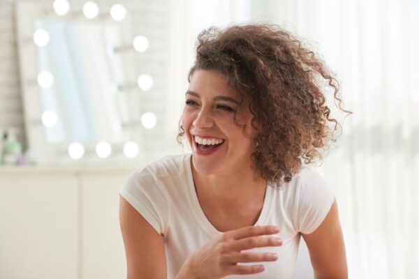 A woman laughing at a roof joke