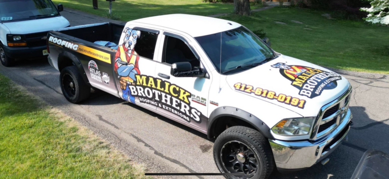 White roofing truck wrap with a dog logo