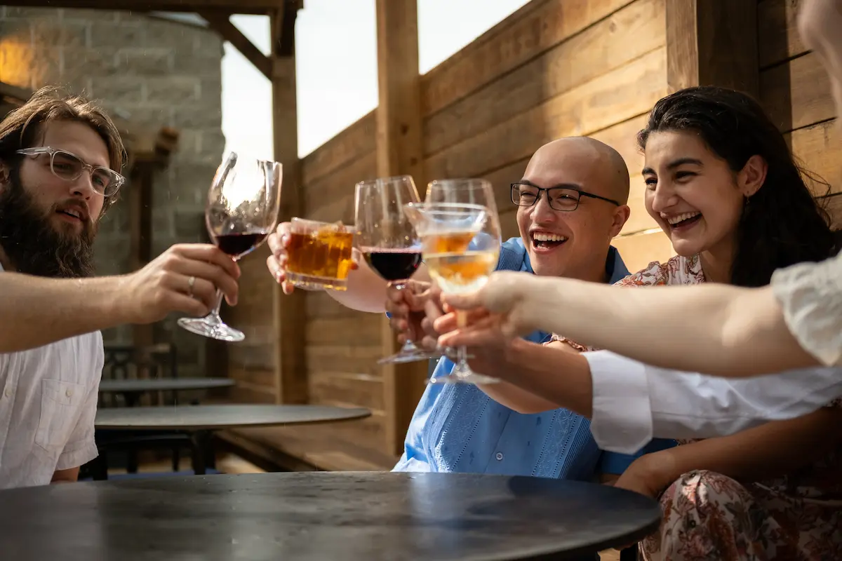 A group of happy patrons holding up their drinks
