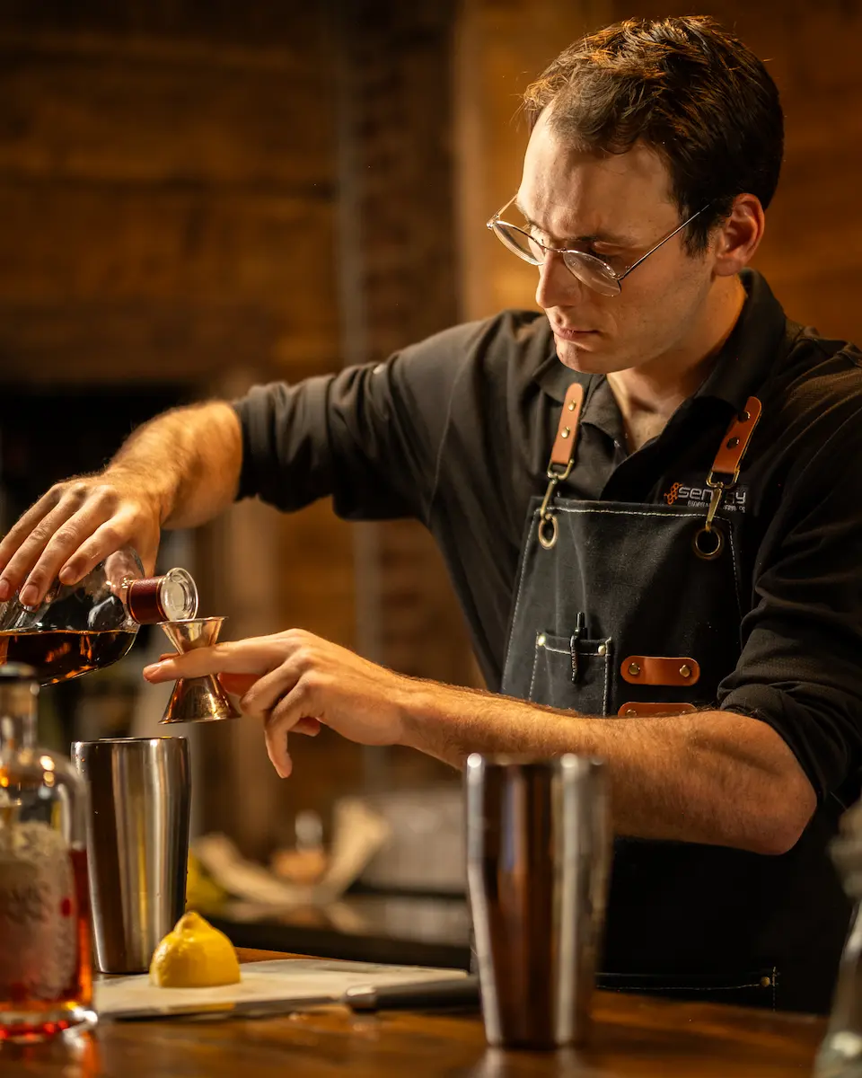 A barkeeper making a drink