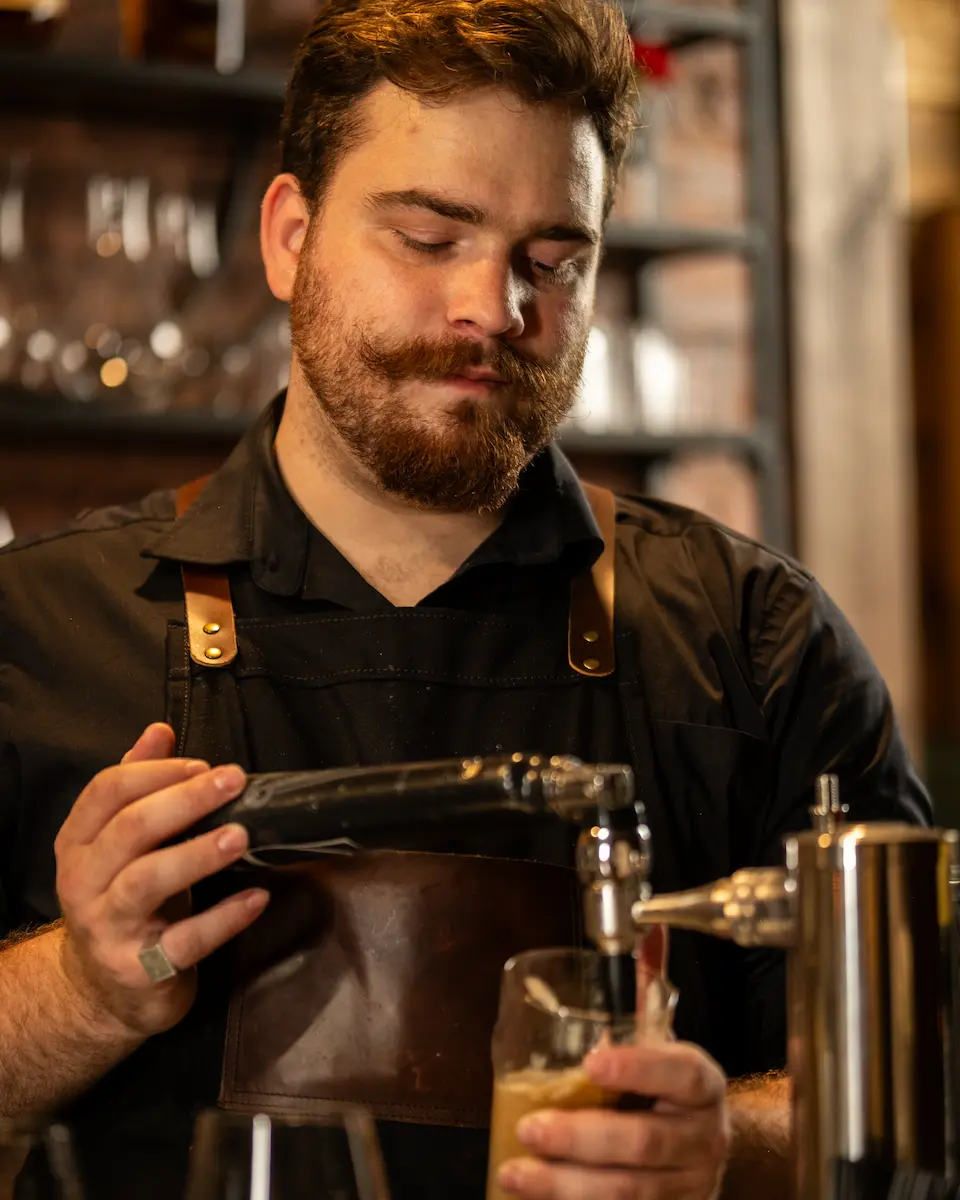 A barkeeper filling a glass