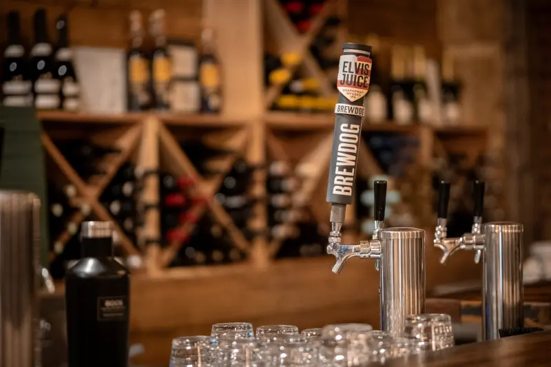 Beer taps at the Paradiso bar with wine racks behind