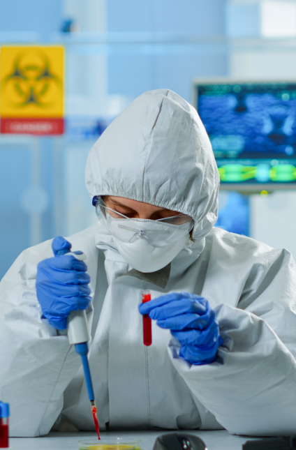 Lab technician in hazmat suit conducting chemical research for safe and effective pest control solutions