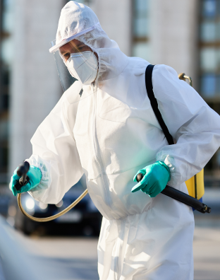 Licensed pest control technician in protective gear carrying out extermination procedures

